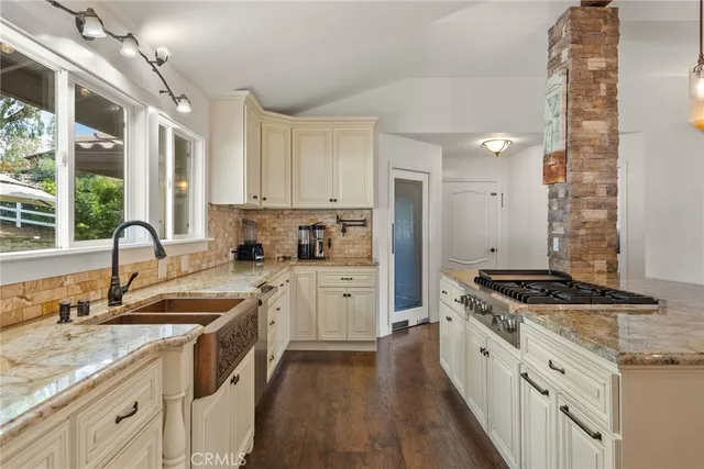 a spacious bedroom with a bed a window and a chandelier