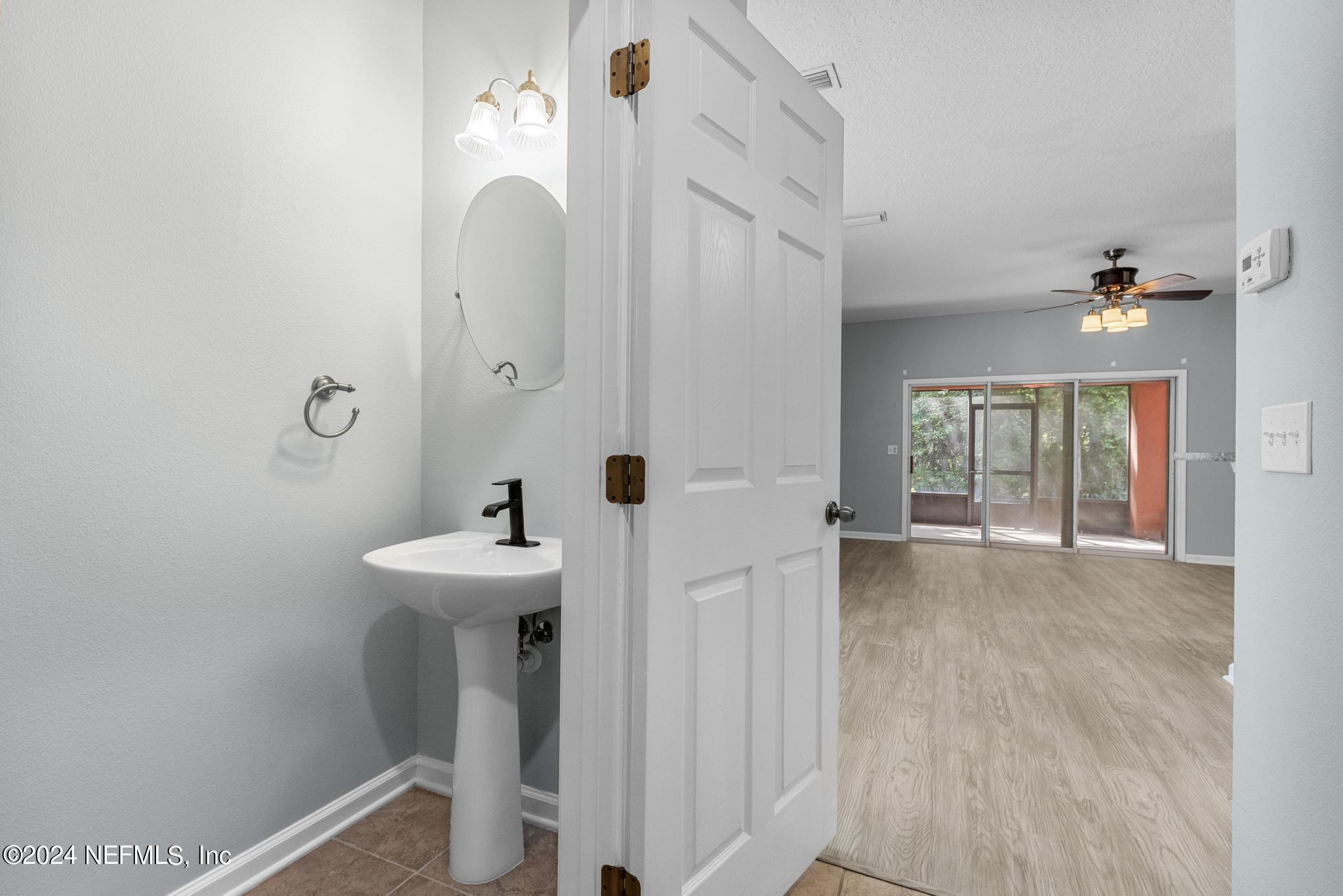 12939 Spring Rain Road Jacksonville, FL 32258 - Photo 11 of 30 a bathroom with a sink a toilet and mirror