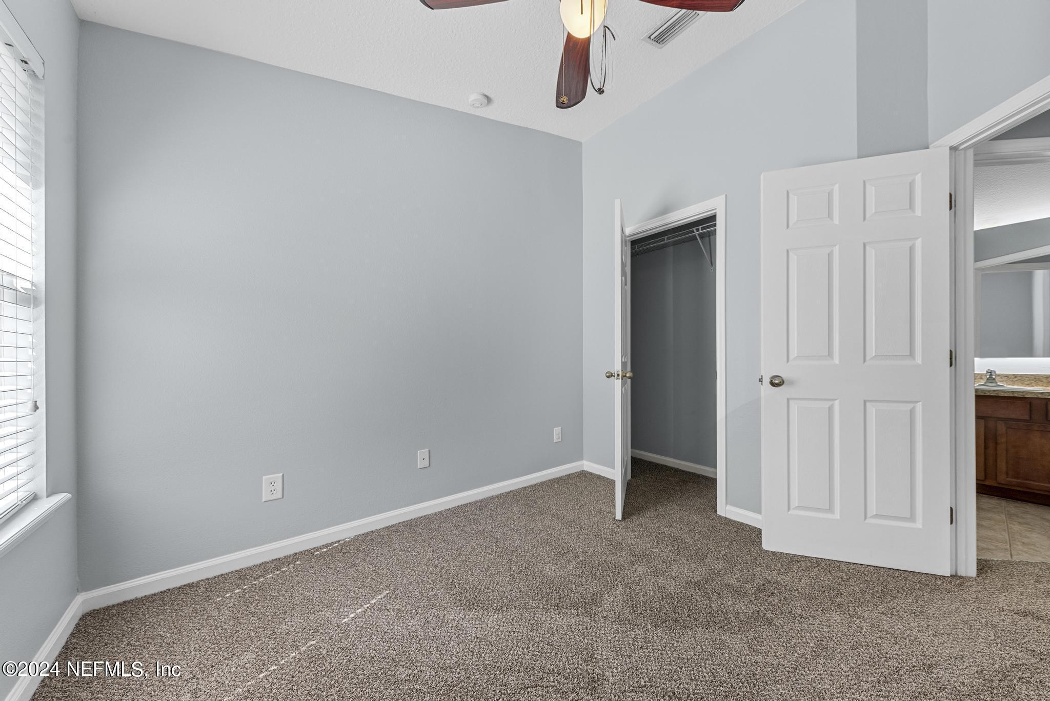 12939 Spring Rain Road Jacksonville, FL 32258 - Photo 13 of 30 an empty room with a empty space and windows