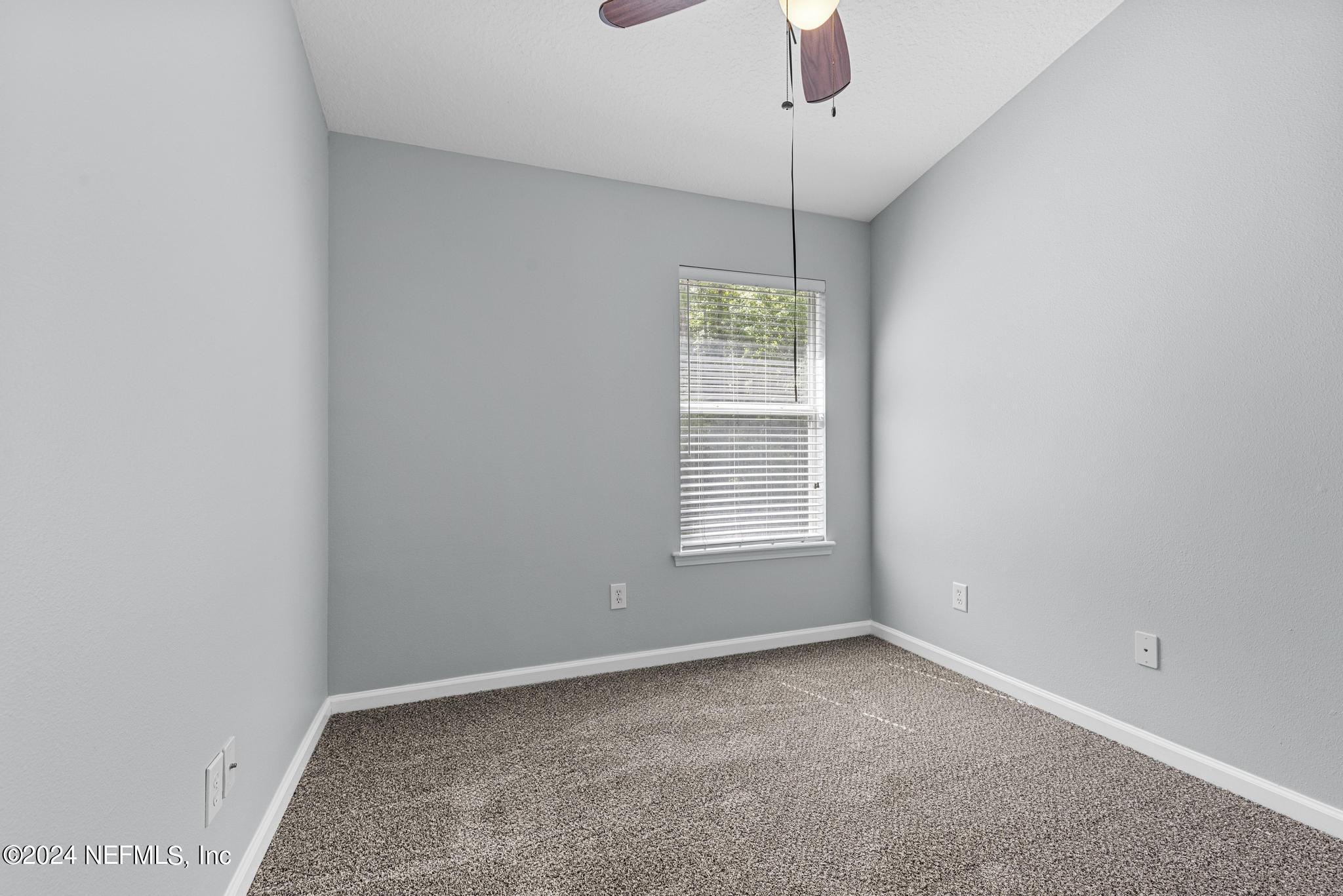12939 Spring Rain Road Jacksonville, FL 32258 - Photo 14 of 30 an empty room with a empty space and a window