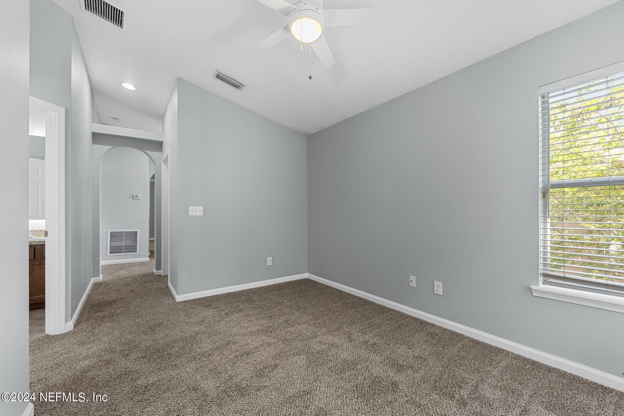 12939 Spring Rain Road Jacksonville, FL 32258 - Photo 17 of 30 an empty room with windows and closet