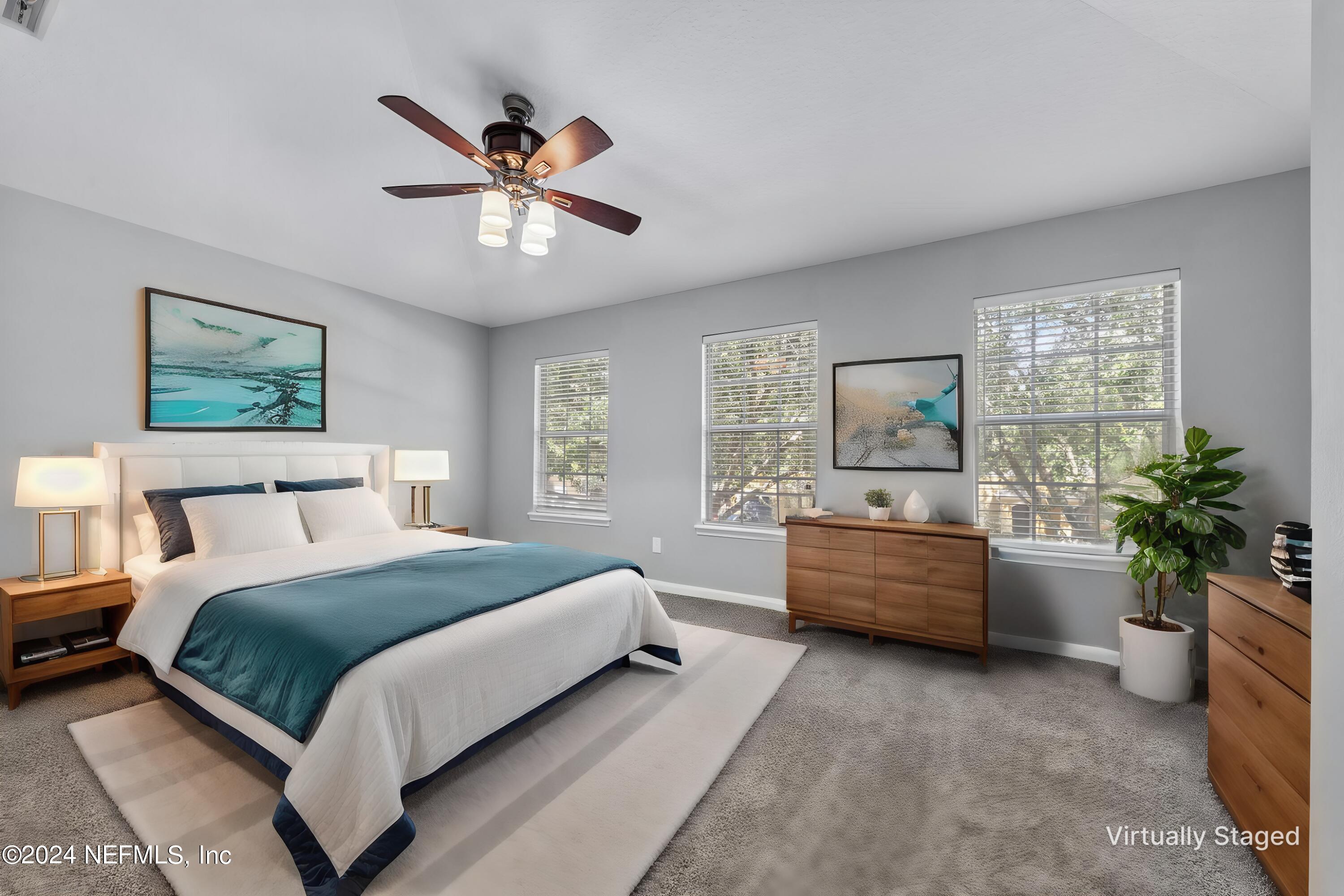 12939 Spring Rain Road Jacksonville, FL 32258 - Photo 19 of 30 a bedroom with a large bed and a window