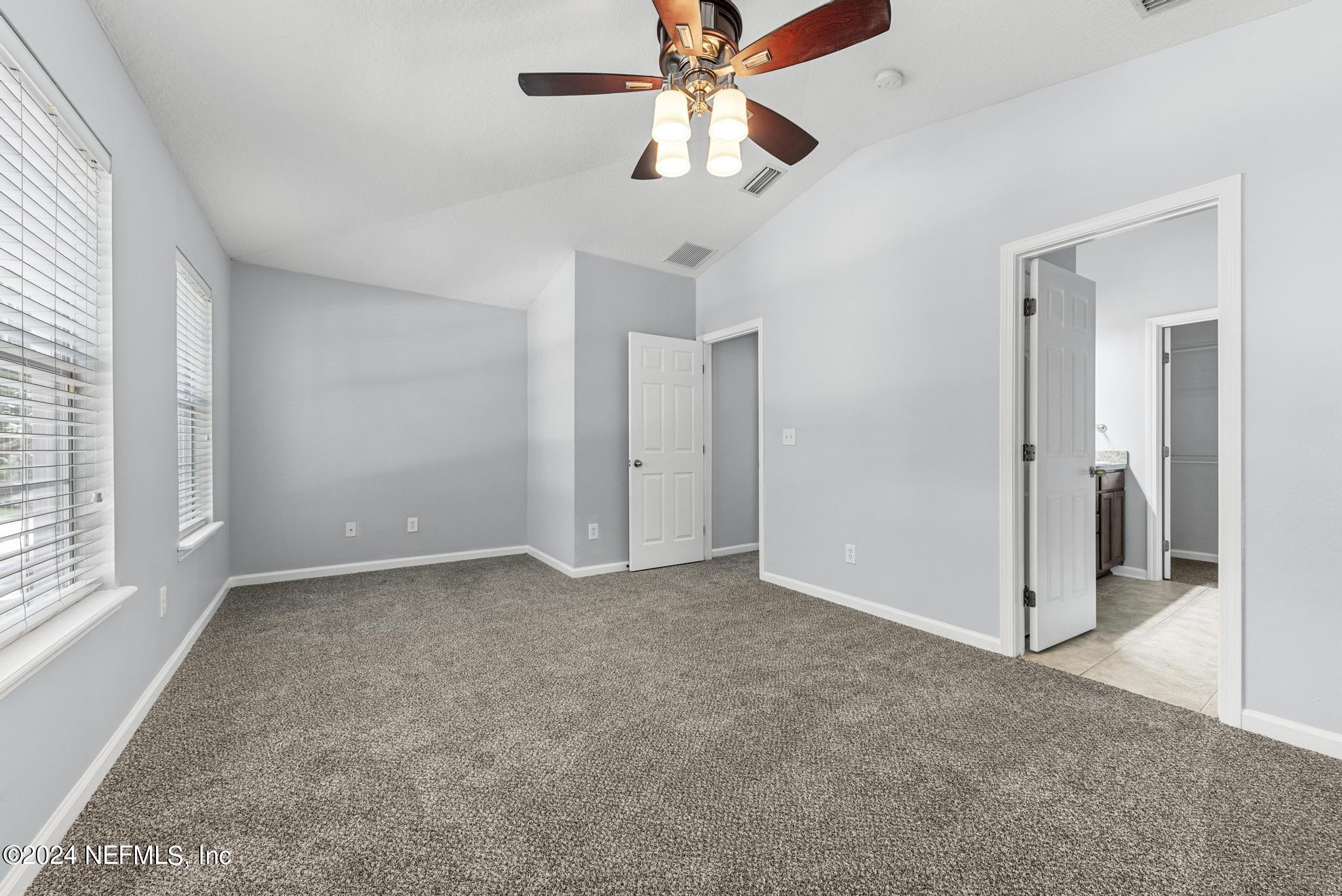 12939 Spring Rain Road Jacksonville, FL 32258 - Photo 21 of 30 an empty room with fan and windows