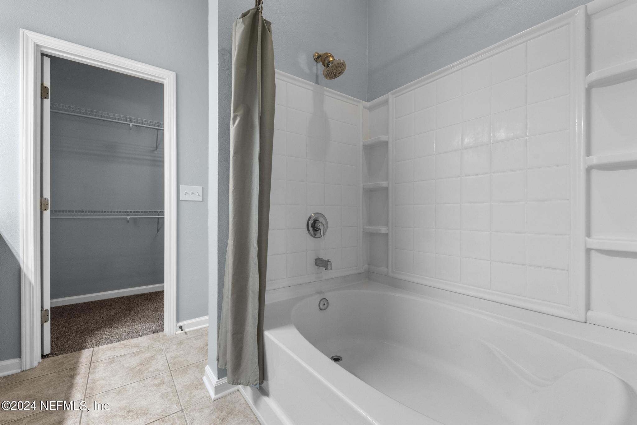 12939 Spring Rain Road Jacksonville, FL 32258 - Photo 22 of 30 a bathroom with a bathtub