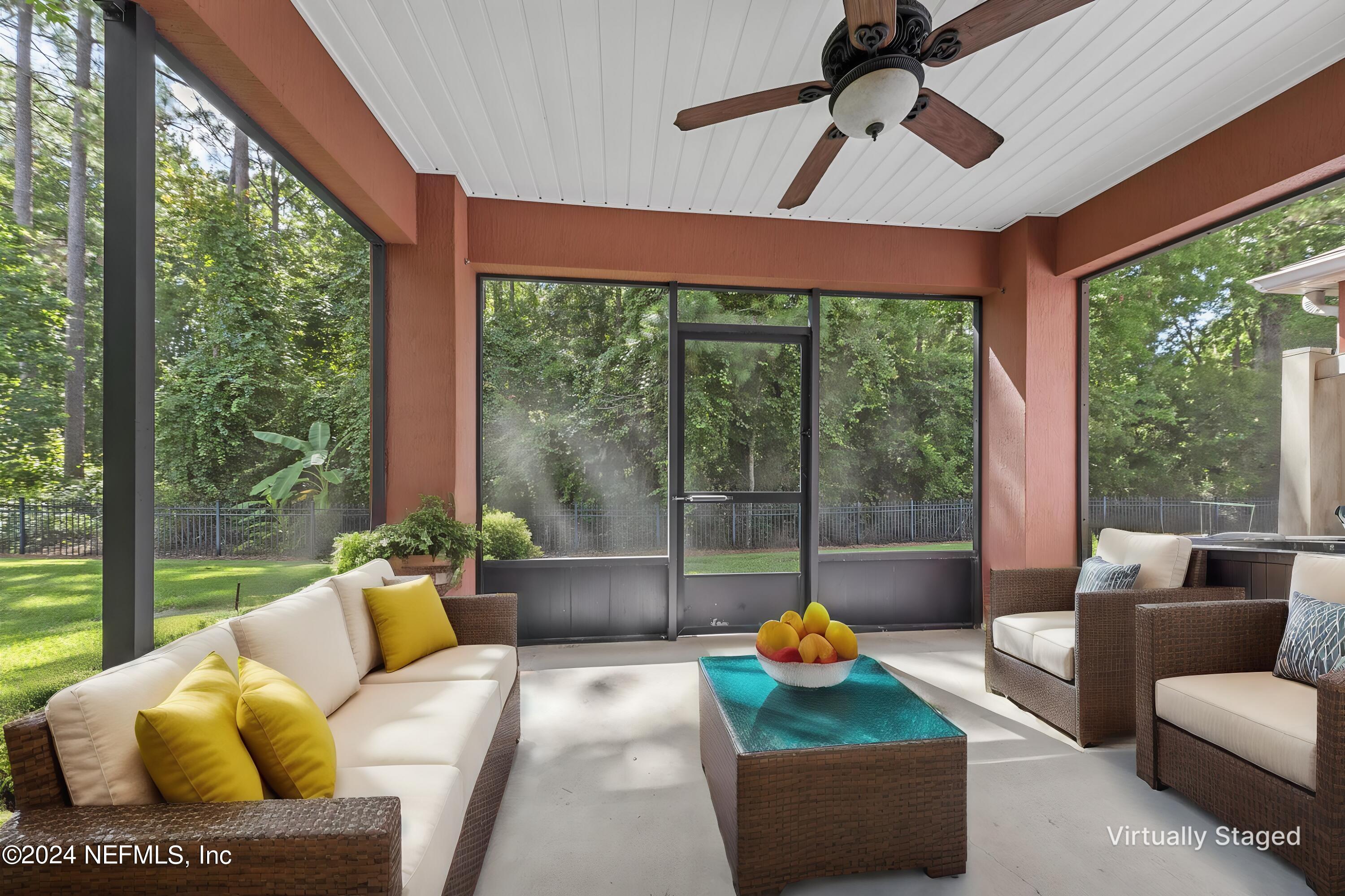 12939 Spring Rain Road Jacksonville, FL 32258 - Photo 25 of 30 a living room with furniture and a floor to ceiling window