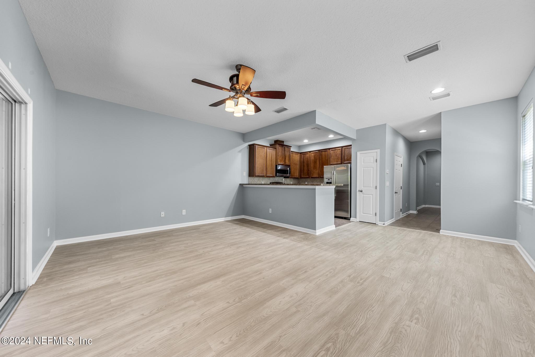 12939 Spring Rain Road Jacksonville, FL 32258 - Photo 6 of 30 a view of a room with a cabinet and a flat screen tv