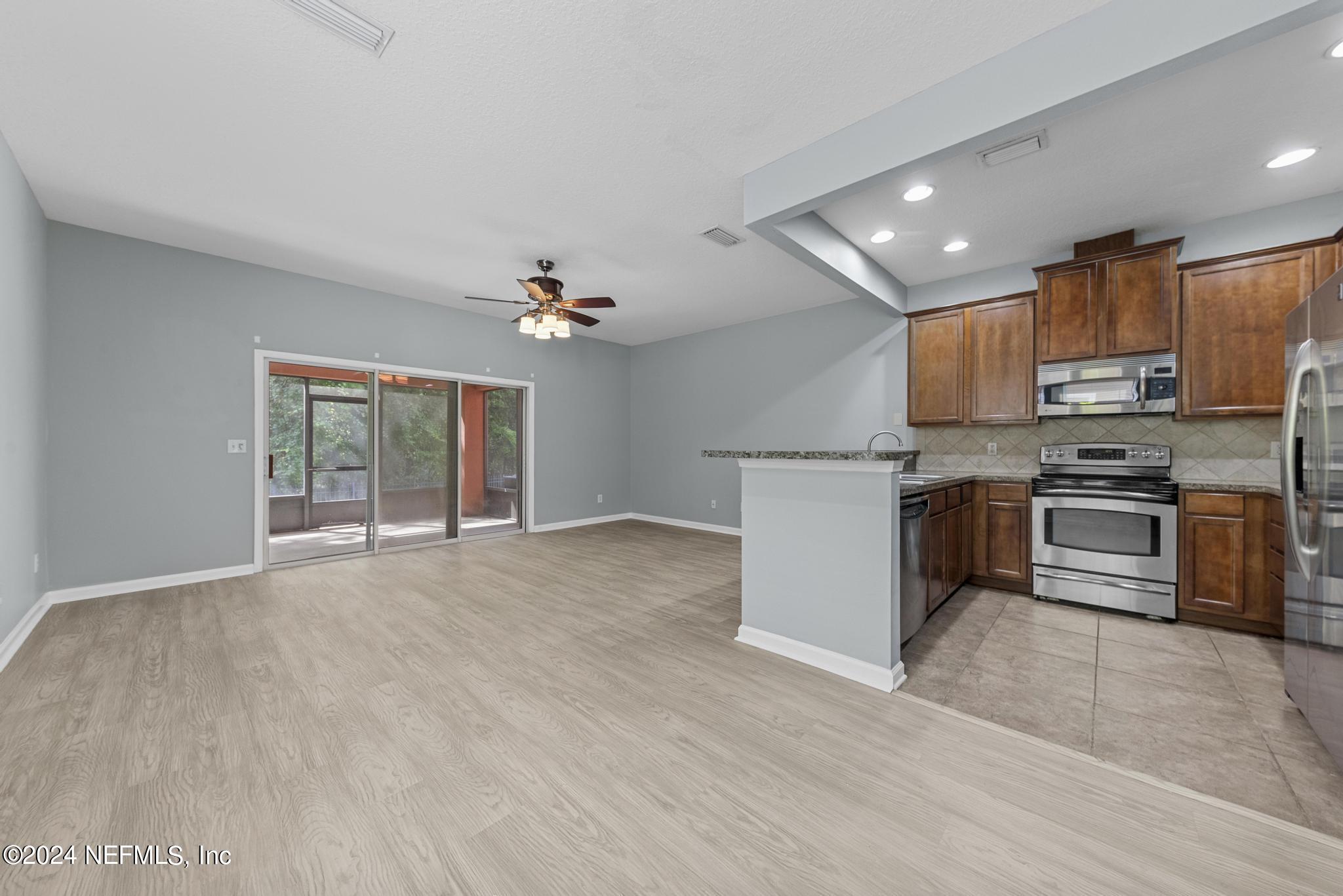 12939 Spring Rain Road Jacksonville, FL 32258 - Photo 8 of 30 a kitchen with stainless steel appliances a refrigerator sink and stove