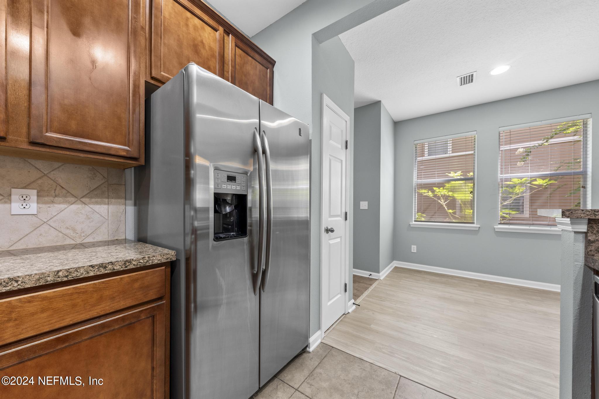 12939 Spring Rain Road Jacksonville, FL 32258 - Photo 10 of 30 a kitchen with stainless steel appliances granite countertop a refrigerator and a stove