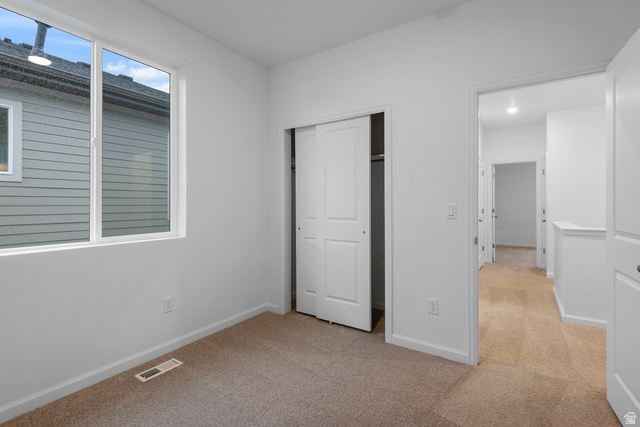 1302 East 1670th North, Unit 908 Payson, UT 84651 - Photo 13 of 21 Unfurnished bedroom with light colored carpet and a closet