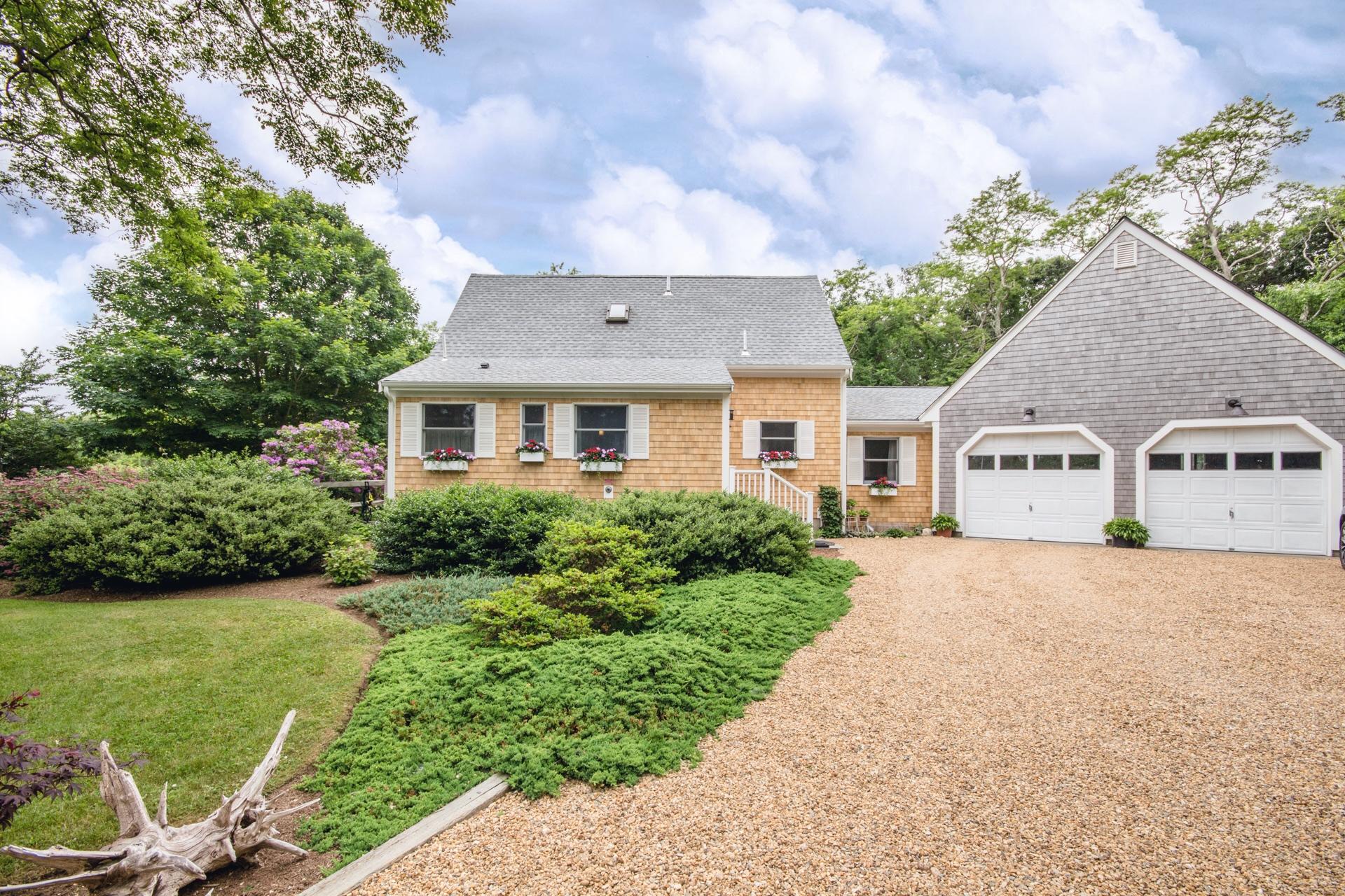 5 Marchants Path Edgartown, MA 02539 - Photo 1 of 45 a front view of a house with a yard and garage