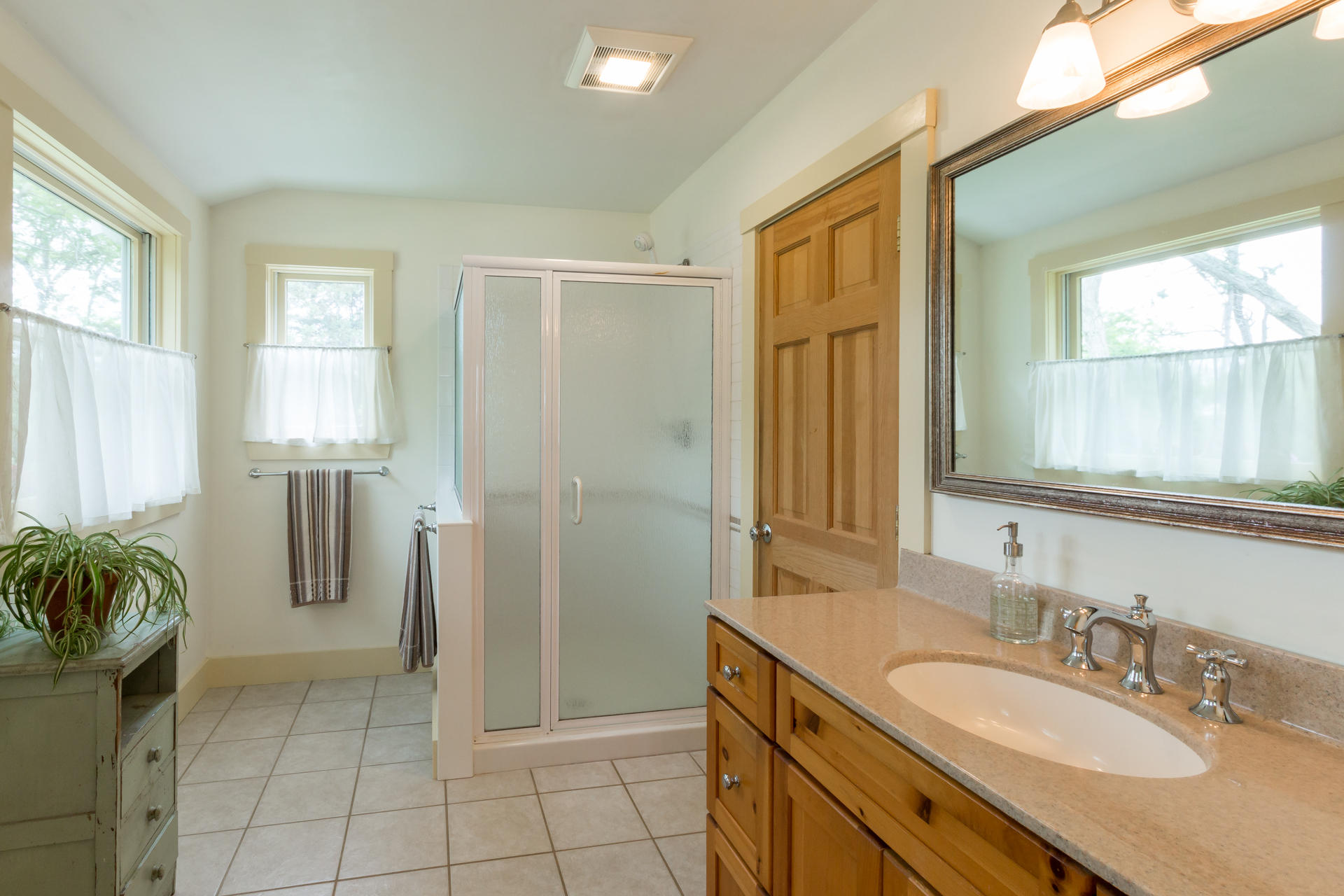 5 Marchants Path Edgartown, MA 02539 - Photo 7 of 45 a spacious bathroom with a granite countertop sink a mirror and a shower
