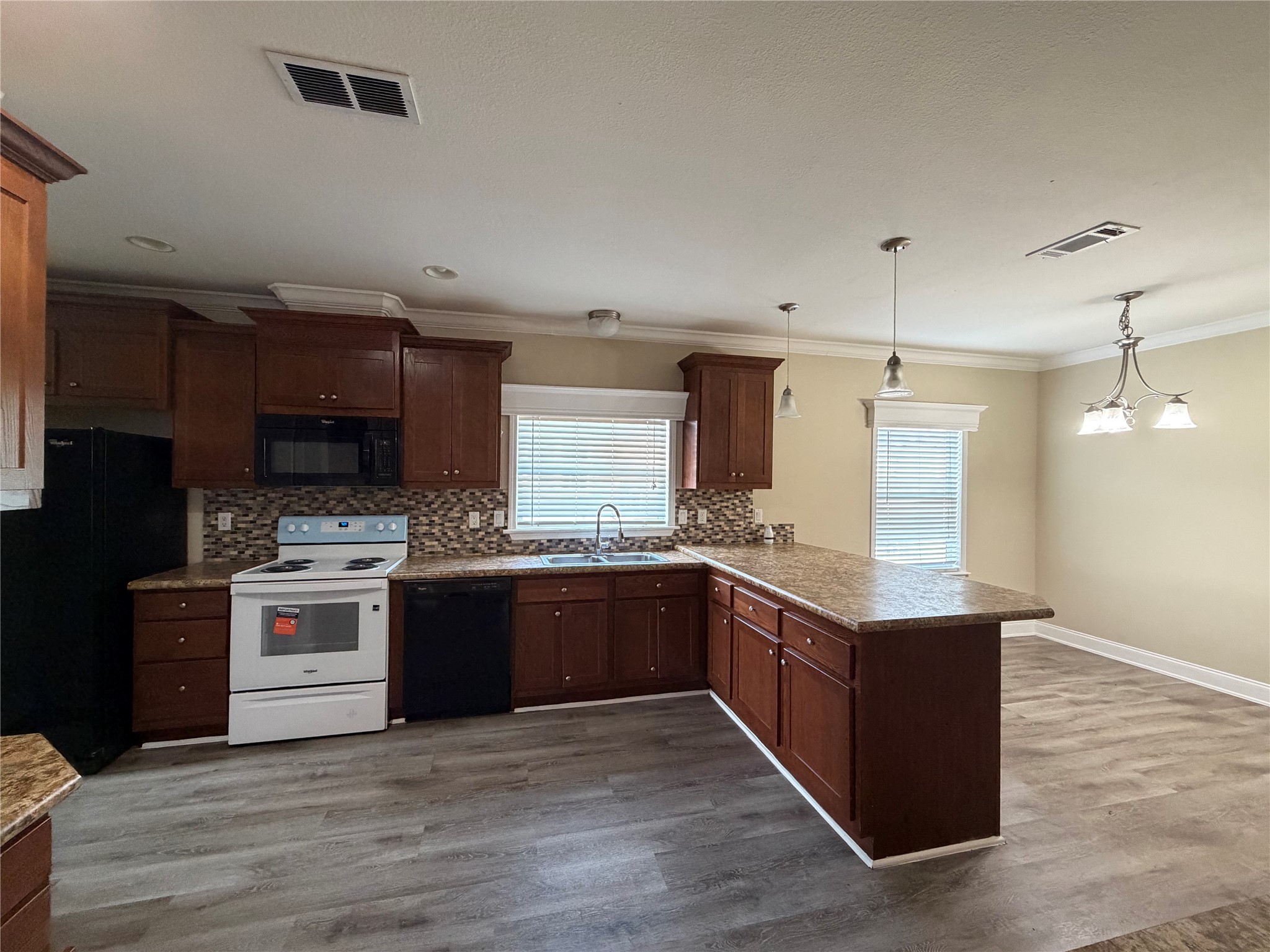 13021 Dessau Road, Unit 393 Austin, TX 78754 - Photo 5 of 10 Rich wood cabinetry and a generous breakfast bar define this open kitchen design.