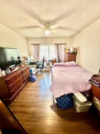 a bed room with furniture and a flat screen tv