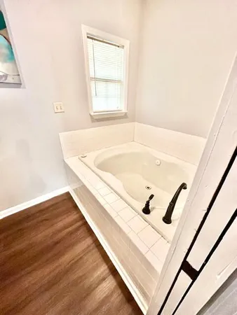 a bath tub sitting next to a window