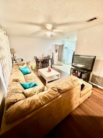 a bed sitting in a bedroom next to a larger window