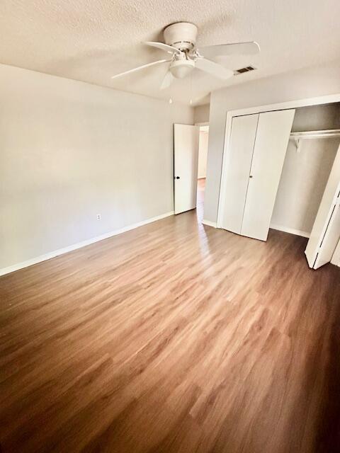 423 John King Road Crestview, FL 32539 - Photo 22 of 28 an empty room with wooden floor ceiling fan and windows