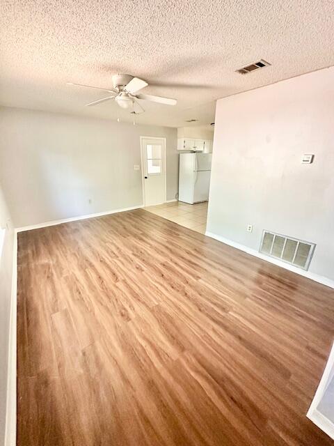 423 John King Road Crestview, FL 32539 - Photo 3 of 28 a view of empty room with wooden floor and fan