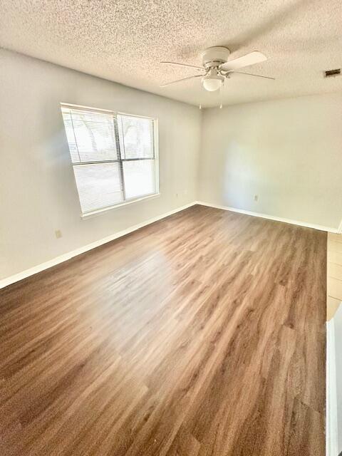 423 John King Road Crestview, FL 32539 - Photo 4 of 28 an empty room with wooden floor and windows