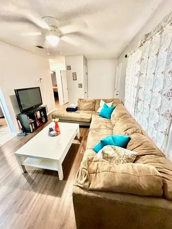 a living room with furniture and a flat screen tv