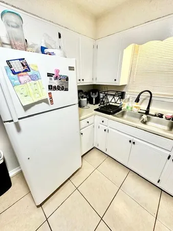 a utility room with cabinets washer and dryer