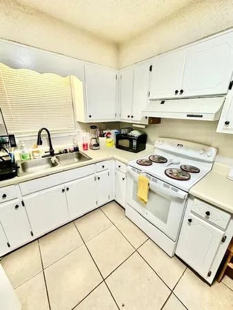 a kitchen with cabinets and appliances