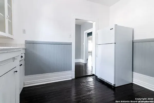 a view of a walk in closet with wooden floor
