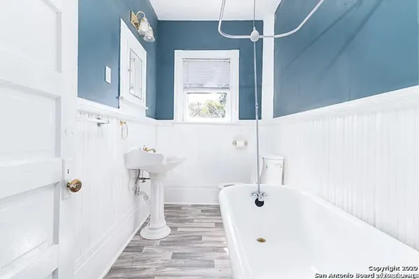 a bathroom with a bathtub and a sink