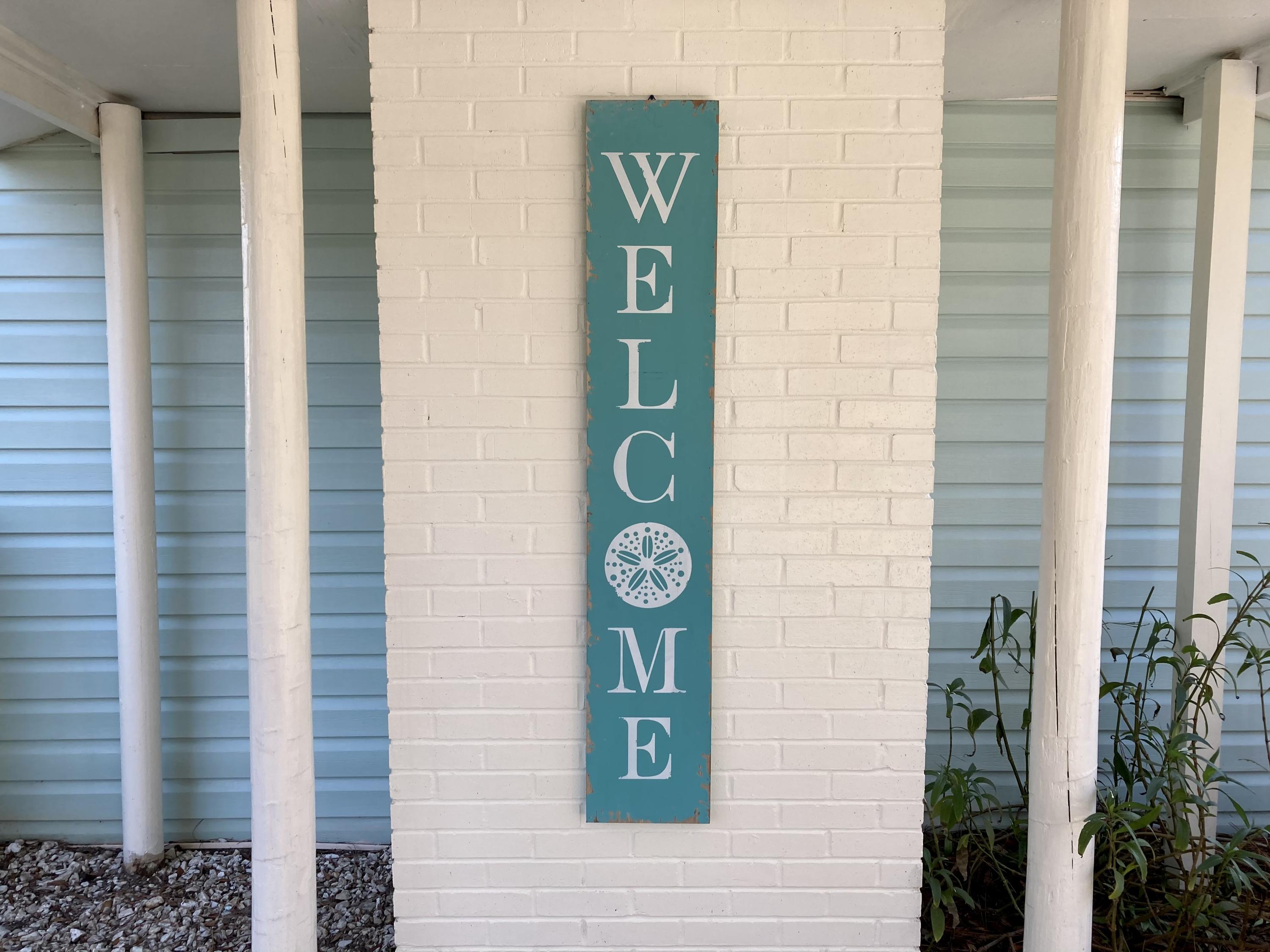 10 East Wild Briar Road Santa Rosa Beach, FL 32459 - Photo 1 of 54 a sign that is on a wooden wall