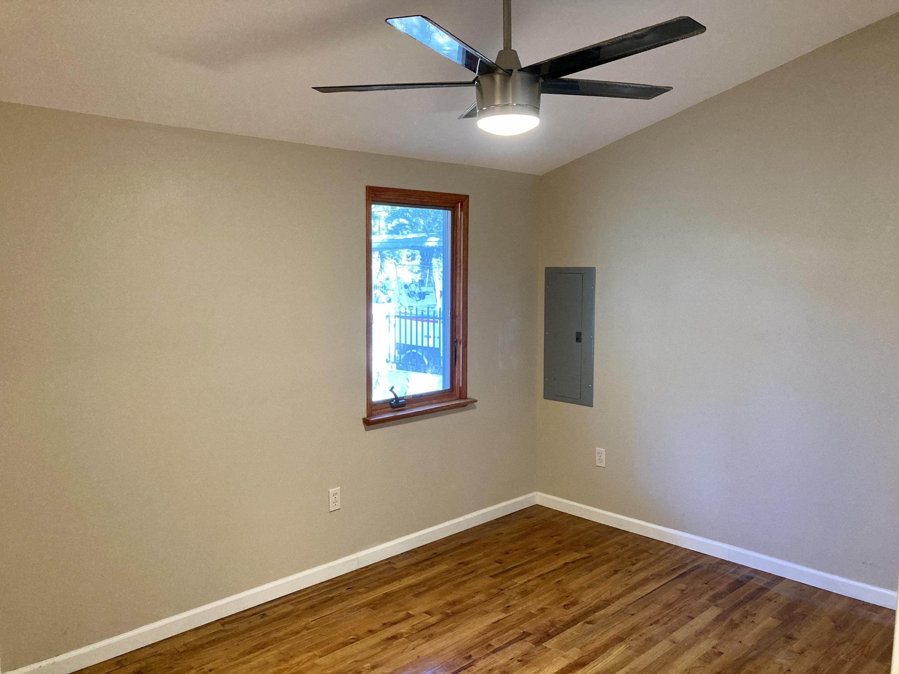 10 East Wild Briar Road Santa Rosa Beach, FL 32459 - Photo 25 of 54 an empty room with wooden floor fan and windows