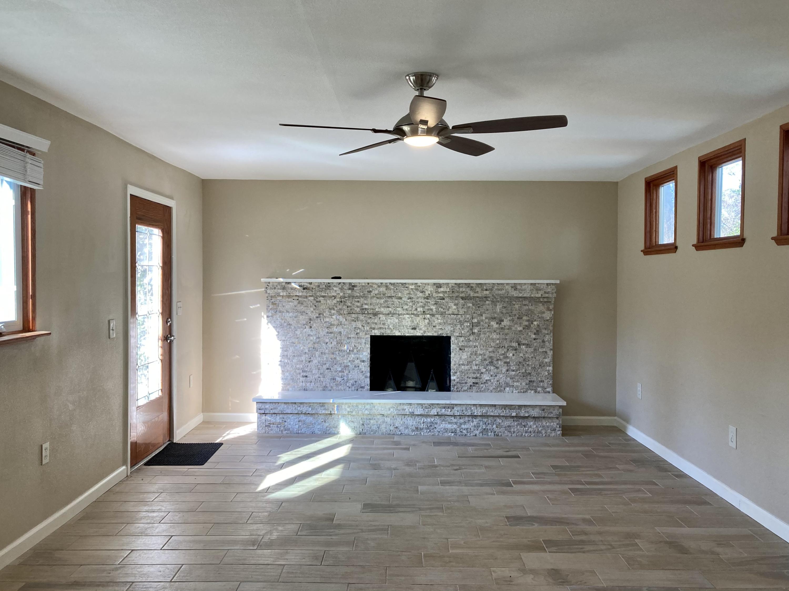 10 East Wild Briar Road Santa Rosa Beach, FL 32459 - Photo 5 of 54 a living room with a fireplace and wooden floor