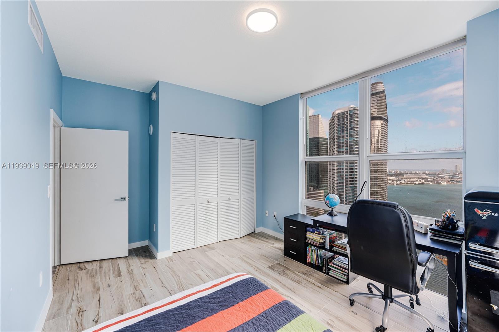 31 Southeast 5th Street, Unit 3918 Miami, FL 33131 - Photo 13 of 24 a view of a workspace with furniture and a window