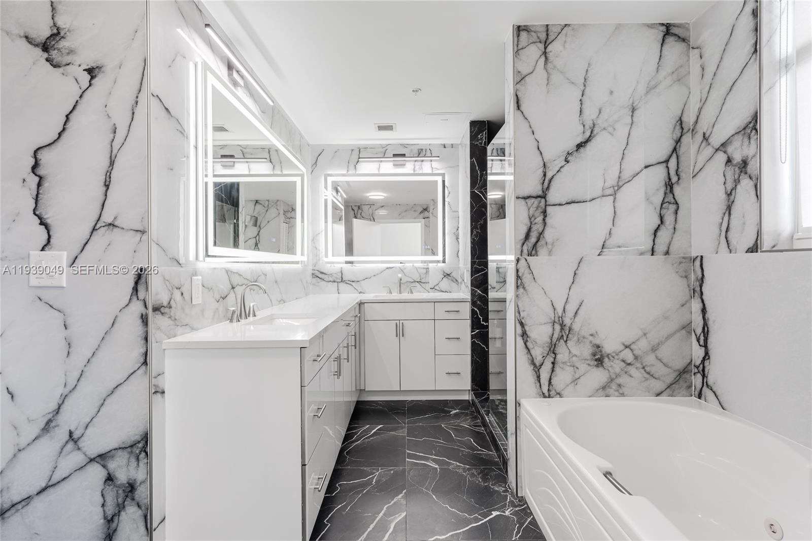 31 Southeast 5th Street, Unit 3918 Miami, FL 33131 - Photo 20 of 24 a bathroom with a sink and a bathtub