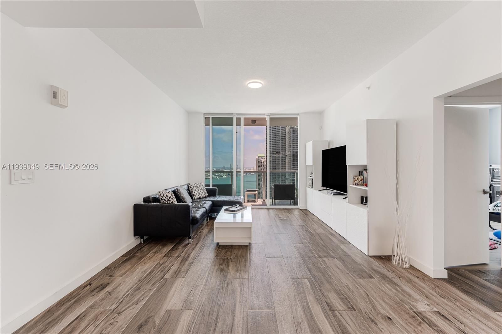 31 Southeast 5th Street, Unit 3918 Miami, FL 33131 - Photo 6 of 24 a view of a livingroom with furniture and a flat screen tv