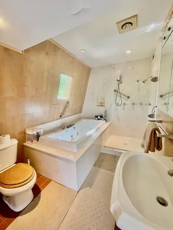 a bathroom with a sink a toilet and a mirror