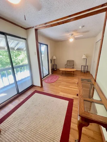 a room with pool table and windows