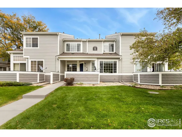 a backyard of a house with yard table and chairs