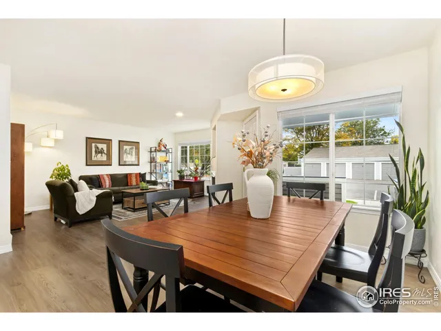 a living room with dining room and wooden floor