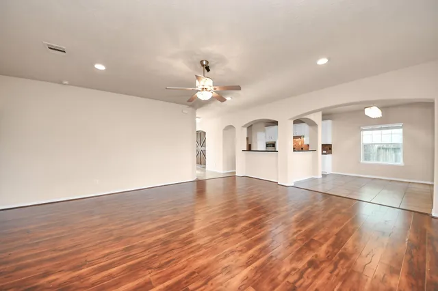 wooden floor in an empty room with a window
