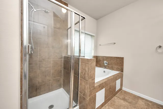 a bathroom with a bathtub and a shower