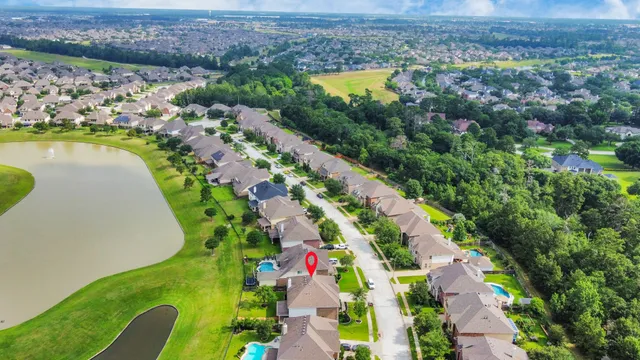 an aerial view of a house with a garden and swimming pool