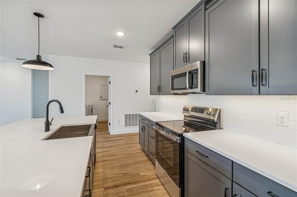 3617 Southwest 153rd Pl Road, Unit 6 Ocala, FL 34473 - Photo 11 of 31 a kitchen with stainless steel appliances a sink stove and refrigerator
