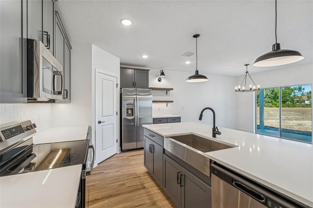 3617 Southwest 153rd Pl Road, Unit 6 Ocala, FL 34473 - Photo 12 of 31 a kitchen with stainless steel appliances a sink a stove and a refrigerator
