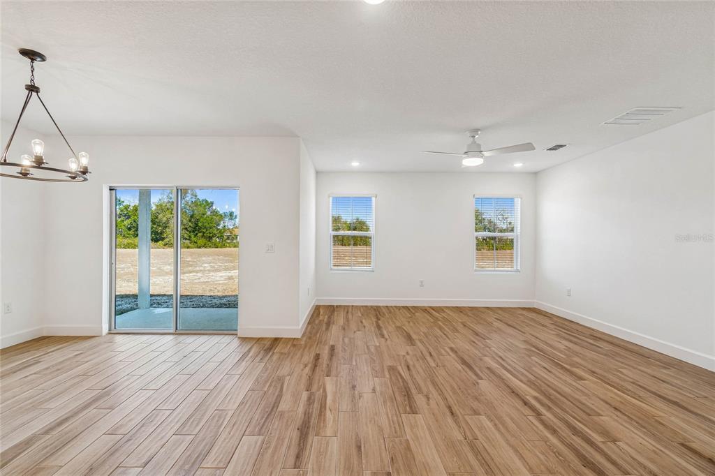 3617 Southwest 153rd Pl Road, Unit 6 Ocala, FL 34473 - Photo 18 of 31 a view of empty room with wooden floor and fan