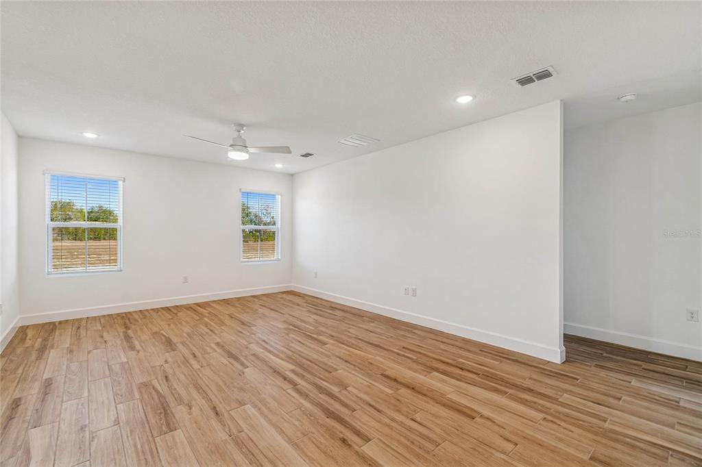 3617 Southwest 153rd Pl Road, Unit 6 Ocala, FL 34473 - Photo 19 of 31 a view of an empty room with wooden floor and a window
