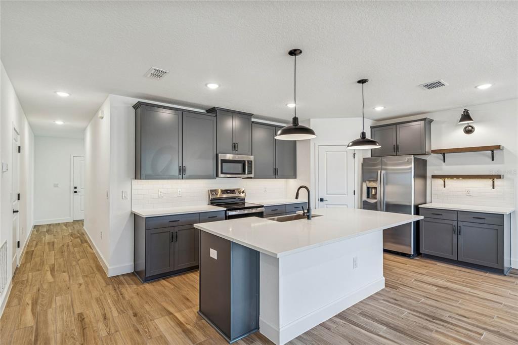 3617 Southwest 153rd Pl Road, Unit 6 Ocala, FL 34473 - Photo 7 of 31 a kitchen with stove a sink and refrigerator