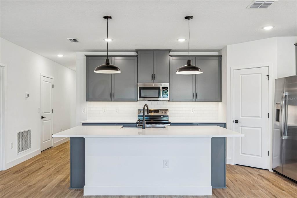 3617 Southwest 153rd Pl Road, Unit 6 Ocala, FL 34473 - Photo 8 of 31 a kitchen with stainless steel appliances granite countertop a sink stove and refrigerator