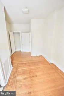 a big room with wooden floor and bedroom view