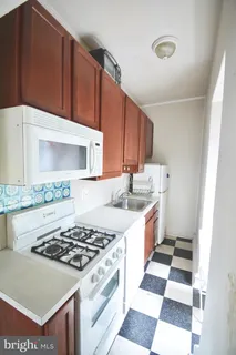 a kitchen with a stove a sink and a microwave
