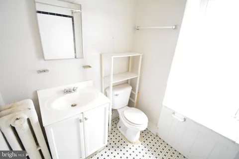 a white toilet sitting next to a bathroom sink
