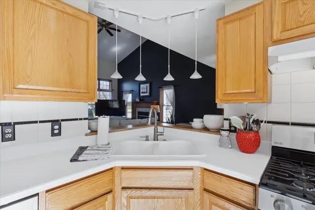 a kitchen with a sink and a stove top oven